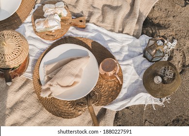 Beautiful summer picnic on the beach at sunset in boho style. Organic fresh ciabatta sandwich on wooden  with natural lemonade on linen blanket. Vegetarian eco idea for weekend picnic.