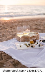 Beautiful Summer Picnic At Sunset On Beach With White Wine, Pizza, Cheese, Olives And Fresh Fruits.