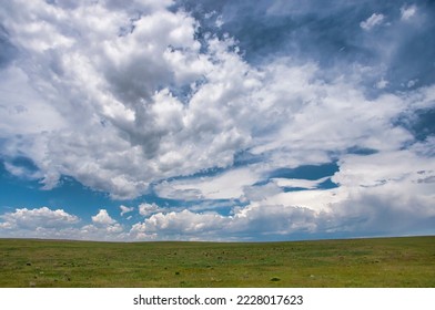 A beautiful summer sky as afternoon storms start developing over the Pawnee National Grasslands of northeastern Colorado. - Shutterstock ID 2228017623