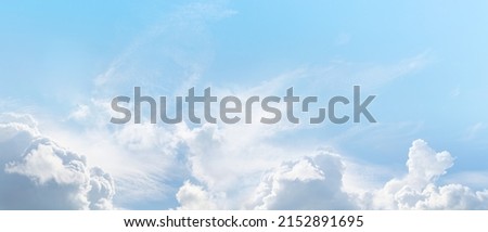 Beautiful summer sky wispy romantic cloudscape - wide pale blue with various cloud formations ideal for vacation holiday getaway travel theme or environment consciousness theme
