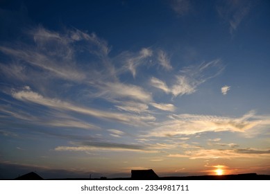 Beautiful summer sunset evening. Blue-yellow clouds of the setting sun. Sunset horizon. - Powered by Shutterstock
