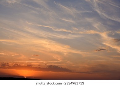 Beautiful summer sunset evening. Blue-yellow clouds of the setting sun. Sunset horizon. - Powered by Shutterstock