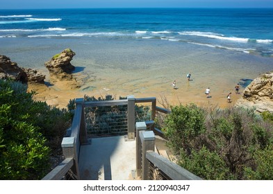 Beautiful summer view of the blue ocean at Point Lonsdale with some tourists exploring the rock pools on the beach. Port Phillip Heads Marine National Park, VIC Australia.