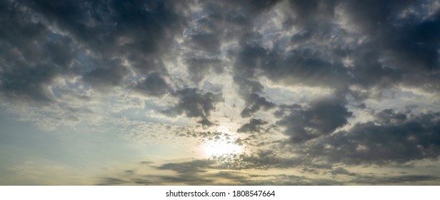 Beautiful sun beams or light rays breaking through the clouds with background of blue sky
