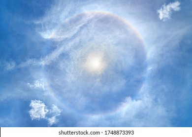 Beautiful Sun Halo With Cloud In The Blue Sky Backgound. Sun With Full Circle Rainbow