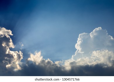 beautiful sun rays through cloud above clear blue heaven sky, sunlight in the summer day
