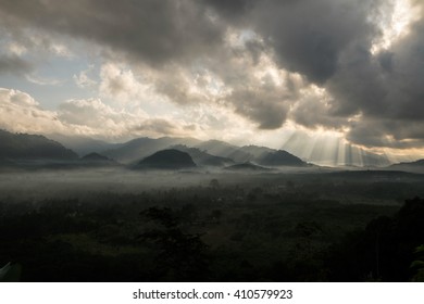 Beautiful sun rays through the clouds over mountains,