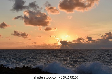 Beautiful Sundown Landscape. Golden Horizon. Two Small Boat Silhouette. Breaking Wave Rough Water In The Grand Cayman Island.