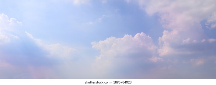 Beautiful sunlight clouds pink-purple in a blue sky. Soft beams in cloud sky background with pastel color natural light midday. Nature is peaceful outdoor, touching sunshine sky summer clouds.