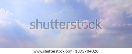 Beautiful sunlight clouds pink-purple in a blue sky. Soft beams in cloud sky background with pastel color natural light midday. Nature is peaceful outdoor, touching sunshine sky summer clouds.