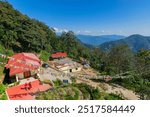 A beautiful sunlit Buddhist Monastery - Samdruptse at Ravangla city, Sikkim , India. Blue cloudy sky above and Himalayan Mountains in the background.