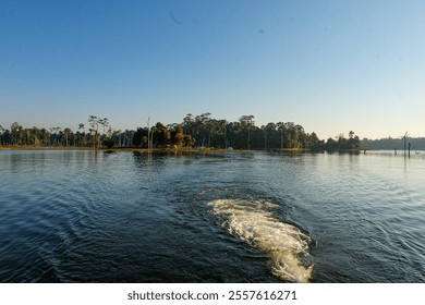 Beautiful sunny camping day, a clear blue sky over Nakai reservoir lake at Thalang, Nakai Plateau, Laos  - Powered by Shutterstock