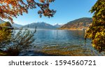 Beautiful Sunny day in Alps. wonderlust view of highland lake With autumn trees under sunlight and perfect sky. Landscape with Alps and Zeller See in Zell am See, Salzburger Land, Austria