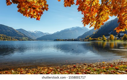 Beautiful Sunny Day In Alps. Wonderlust View Of Highland Lake With Autumn Trees Under Sunlight And Perfect Sky. Landscape With Alps And Zeller See In Zell Am See, Salzburger Land, Austria