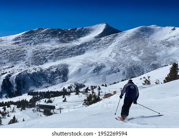 Beautiful Sunny Day At Breckenridge Ski Resort, Colorado - Skier Going Down Trail