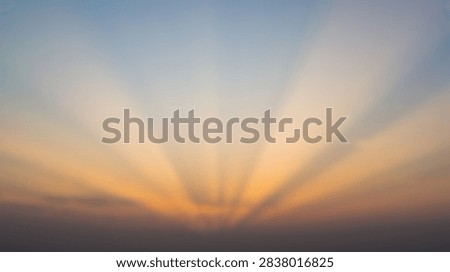 Beautiful sunrise with dramatic light rays spreading across the sky.