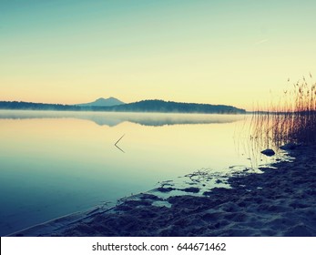 Beautiful Sunrise At Empty Beach, Mediterranean Sea  Island. Peaceful Water Level Makes Blue Mirror