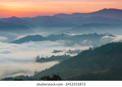 Beautiful sunrise in the morning with sea of mist on hight moutain, Mon Mok Tawan, Tak Province, Thailand. - Powered by Shutterstock