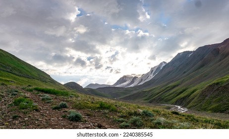 beautiful sunrise in the mountains. snowy mountain peaks under the sun. alpine meadows under snow-capped mountains