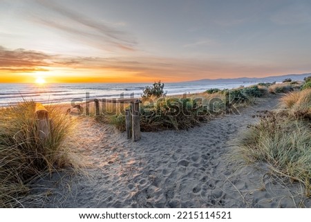 Beautiful sunrise at New Brighton Beach, Christchurch, New Zealand. It is one of eastern country's main entertainment and tourist centers, with its architecturally unique pier and scenic coastline.