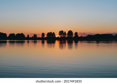 Beautiful sunrise on the lake. Summer day.