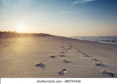 Beautiful Sunrise Over The Atlantic Beach, Footprints On The Sand, North Carolina, USA