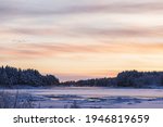 Beautiful sunrise over the frozen Pattasniva river in Savukoski, Finland.