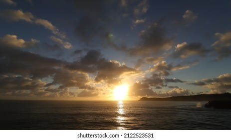 Beautiful Sunrise Over North Haven With Golden Haze And Waves Crashing.