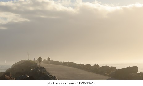 Beautiful Sunrise Over North Haven With Golden Haze And Waves Crashing.