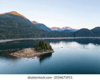 Beautiful sunrise over Stave Lake in Mission, British Columbia. Calm waters reflect lush forests and majestic mountains, creating a peaceful and picturesque scene in Canada. - Powered by Shutterstock