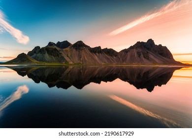 Beautiful sunrise over Vestrahorn mountain range and water reflection in viking village on summer at Stokksnes peninsula, Iceland - Shutterstock ID 2190617929