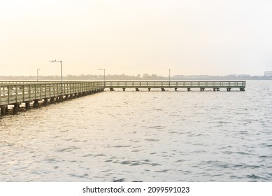 Beautiful sunrise over wooden fishing pier stretching out Clear Lake near Seabrook, Greater Houston, Texas, USA. Foot pier jetty for saltwater fishing. Nature seascape background