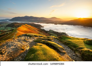 Beautiful Sunrise Overlooking Derwentwater From Catbells On A Sunny Calm Morning With Cloud Inversion Mist Over Lake. Lake District National Park, UK.