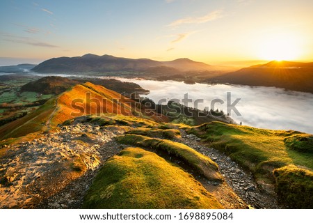 Beautiful Sunrise Overlooking Derwentwater From Catbells On A Sunny Calm Morning With Cloud Inversion Mist Over Lake. Lake District National Park, UK.