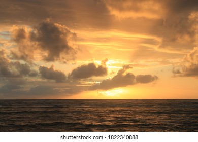 A beautiful sunrise, partially blocked by clouds.  - Shutterstock ID 1822340888