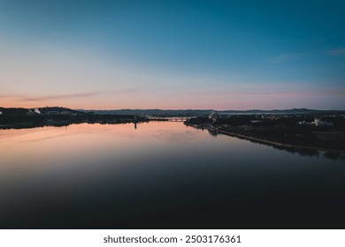 The beautiful sunrise reflecting on lake burley griffin, Canberra, in the morning - Powered by Shutterstock