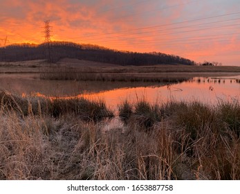 A beautiful sunrise rises up behind the hills at Gupton Wetlands, Swan Pond Recreation Area, Roane County, Tennessee on a late February frosty morning.