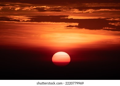 Beautiful Sunrise And Sunset At Horizon Against Orange Sky With Clouds With No People And Serene Darkness Around