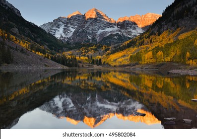 Beautiful Sunrise Touches Maroon Bells Peak At Maroon Lake, Aspen, Colorado. Fall Color Of Aspen And Reflection Of The Mountain