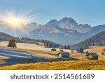 Beautiful sunrise view of meadow Seiser Alm Alpe di Siusi with Odle - Geisler mountain group on background. Morning autumn scenery in Dolomite Alps, South Tyrol, Italy.