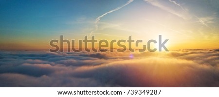 Beautiful sunset above clouds with sunrays