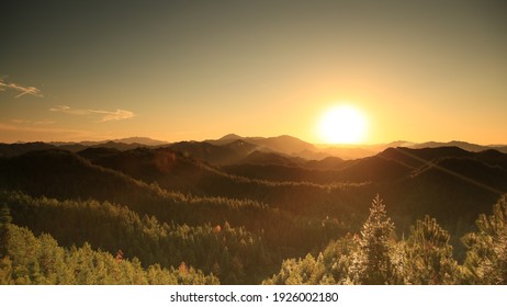 Beautiful sunset above mountains; the forest at orange sunset - Shutterstock ID 1926002180