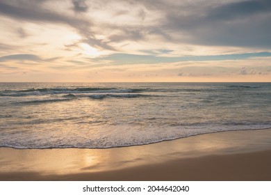 Beautiful Sunset Above Sea Or Ocean With Wave Surf On The Sandy Beach In The Evening, Vacation And Journey Time Tropical, Tranquility Twilight Scene