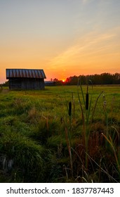 Beautiful sunset and barn in the fields                               