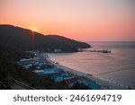 Beautiful sunset beach coast side with mountains, pink colorful sunset summer time holiday traveling tourism, in Ko Lan thailand.