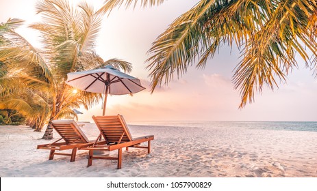 Beautiful sunset beach scene. Chairs on the sandy beach near the sea. Summer holiday and vacation concept for tourism. Inspirational tropical landscape

