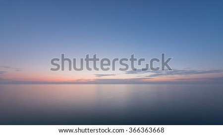 Beautiful sunset with blue sea and sky peaceful background long exposure