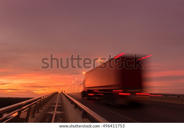 Beautiful sunset\
with Blurred truck on the\
road