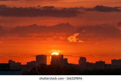 Beautiful sunset with bright Sun over skyline. Moscow, Russia. 
