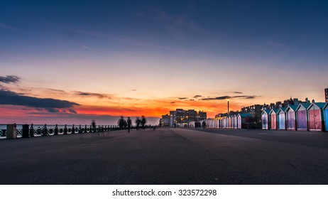 Beautiful sunset in Brighton, UK. Row of beach huts of Hove, vintage effect filter style 